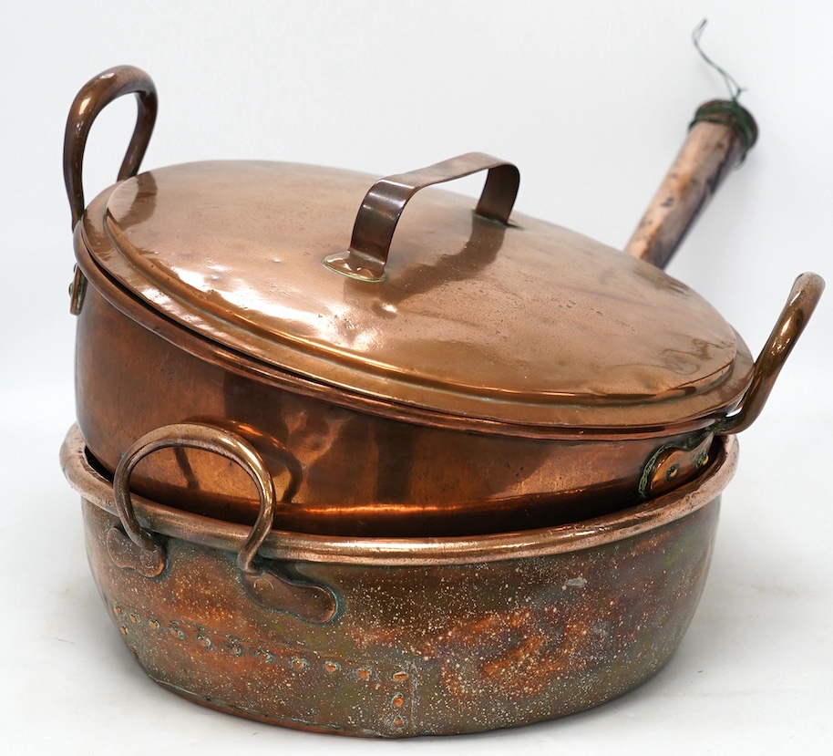 Two copper pans, one handled and the other with cover, 38cm diameter. Condition - fair